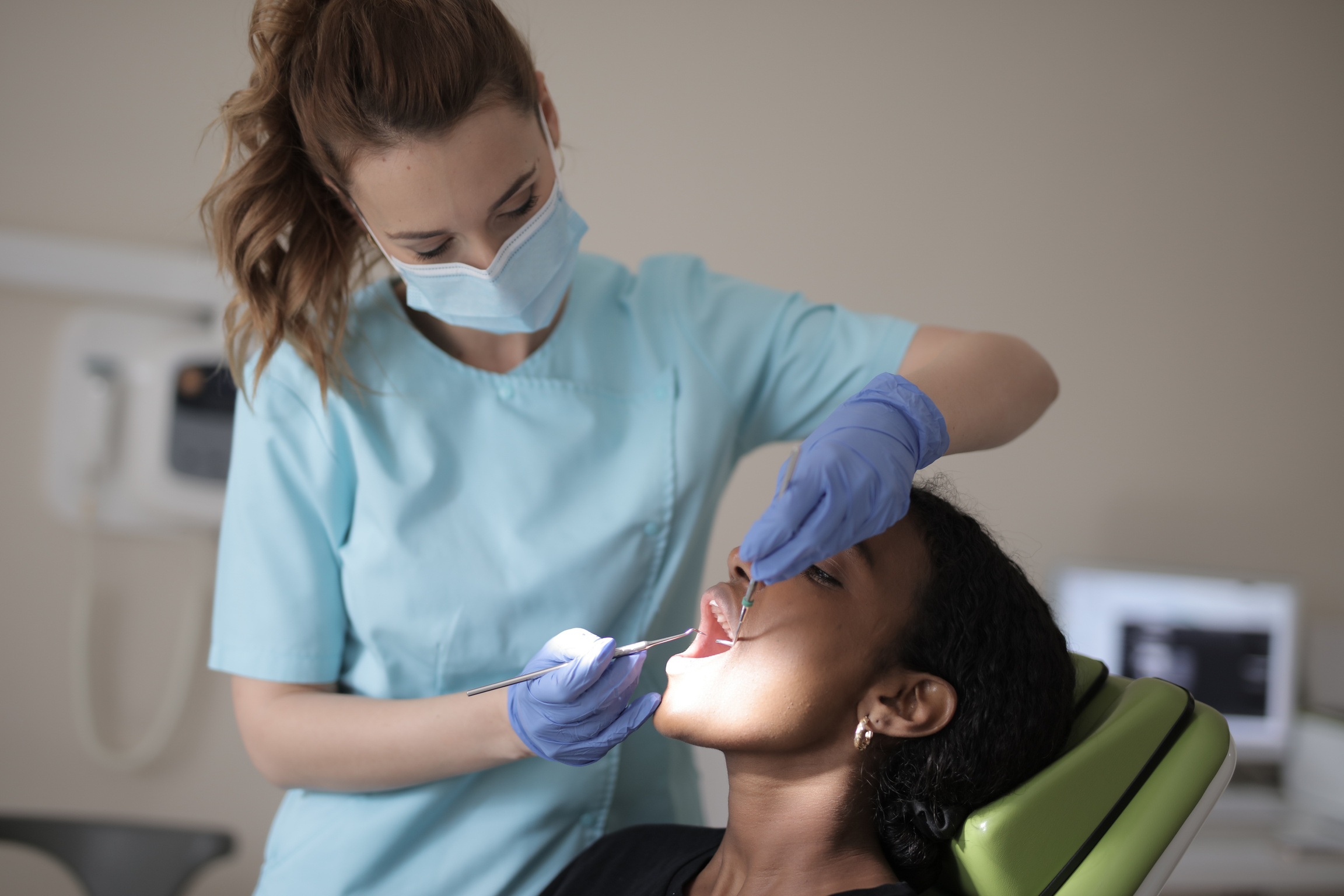 A Dentist Checking On Her Patient